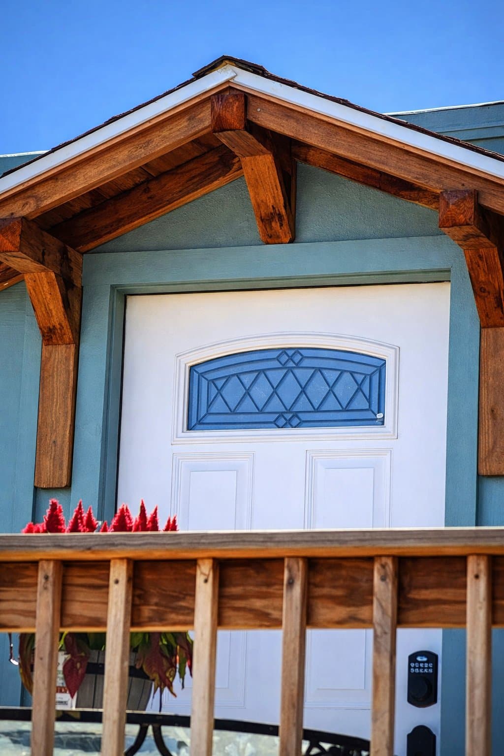 Timber-framed entryway with cedar shake roof by Kevin Breunig